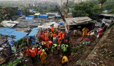 Heavy rains kill 18 in India dozens feared trapped in landslides
